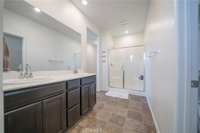 1172 Poinsettia Cir, Calimesa, CA 92320 - bathroom featuring a shower stall, double vanity, and recessed lighting
