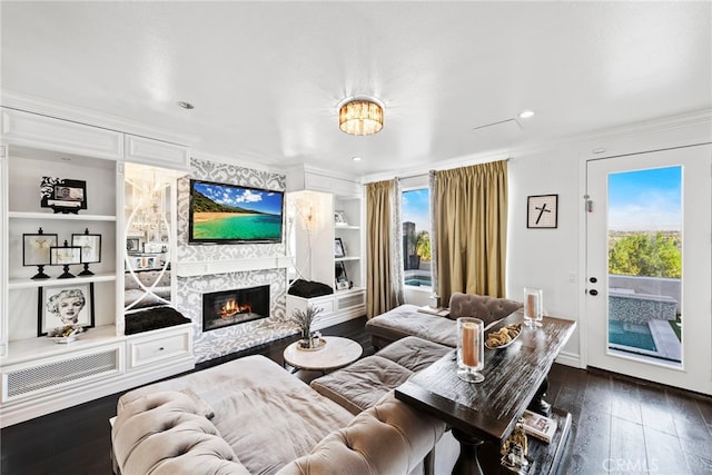 24 Lyon Rdg, Aliso Viejo, CA 92656 - living area featuring ornamental molding, dark wood-style floors, a high end fireplace, built in features, and recessed lighting