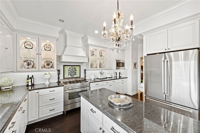 24 Lyon Rdg, Aliso Viejo, CA 92656 - kitchen with appliances with stainless steel finishes, custom range hood, a chandelier, white cabinets, and tasteful backsplash