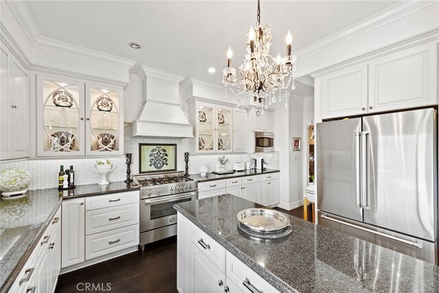 24 Lyon Rdg, Aliso Viejo, CA 92656 - kitchen with appliances with stainless steel finishes, custom range hood, a chandelier, white cabinets, and tasteful backsplash