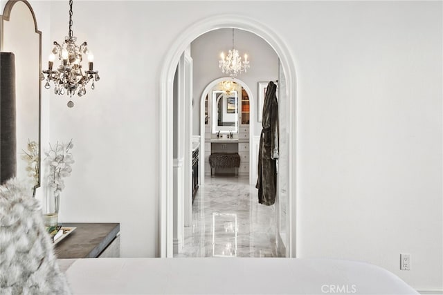 24 Lyon Rdg, Aliso Viejo, CA 92656 - corridor featuring a chandelier, marble tiled flooring, and arched walkways