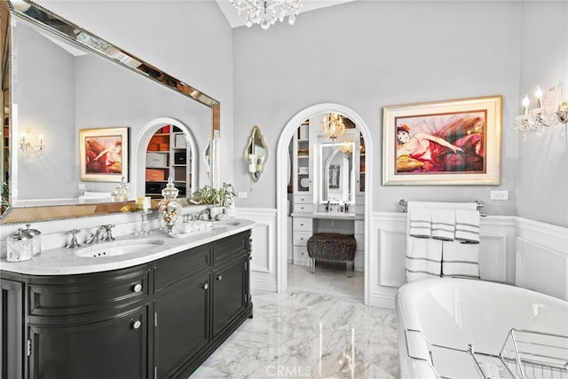 24 Lyon Rdg, Aliso Viejo, CA 92656 - full bathroom featuring a chandelier, wainscoting, double vanity, a freestanding bath, and a decorative wall