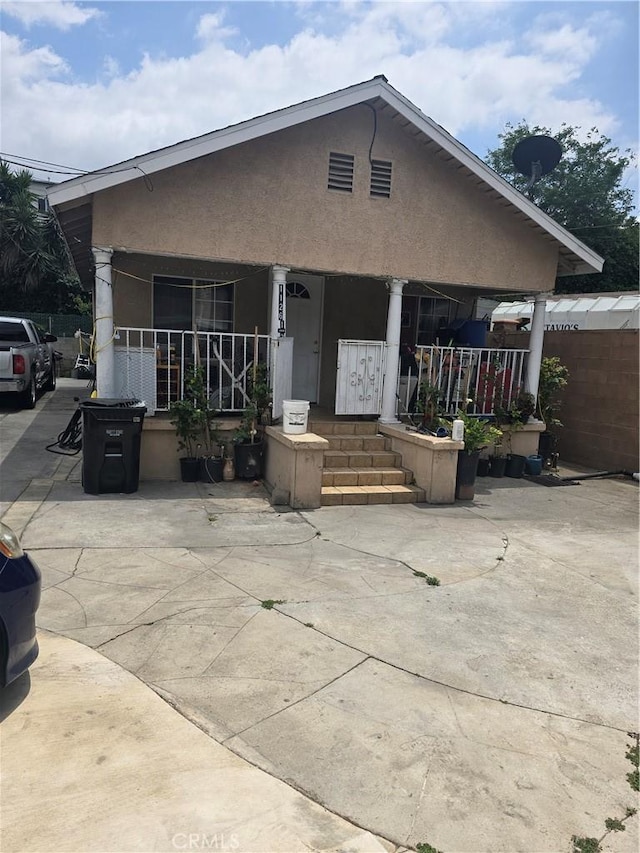 1126 S Dacotah St, Los Angeles, CA 90023 - view of front of property featuring a porch and stucco siding
