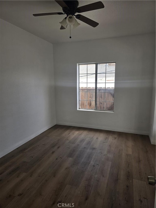 1126 S Dacotah St, Los Angeles, CA 90023 - spare room with dark wood-style flooring, a ceiling fan, and baseboards