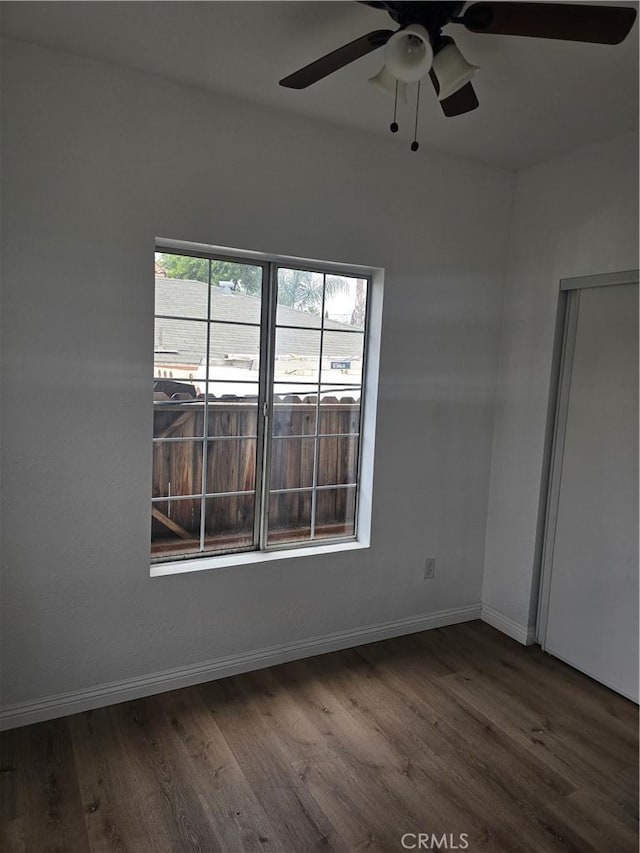 1126 S Dacotah St, Los Angeles, CA 90023 - unfurnished room with dark wood-style floors, a ceiling fan, and baseboards