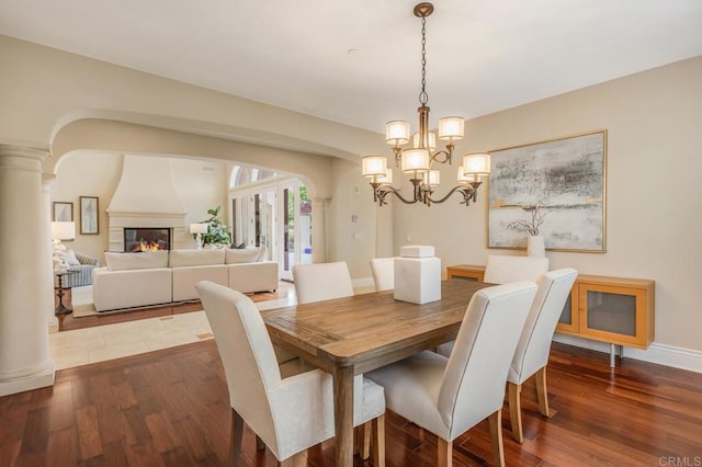 6286 Belmont Trail Ct, San Diego, CA 92130 - dining room featuring dark wood-style floors, a chandelier, baseboards, and a fireplace