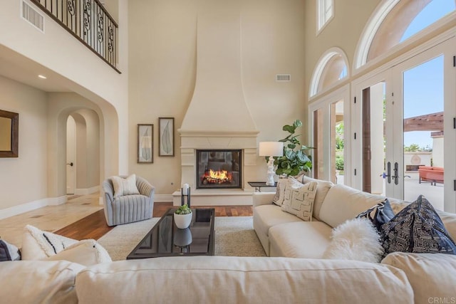 6286 Belmont Trail Ct, San Diego, CA 92130 - living area with a high ceiling, baseboards, arched walkways, a fireplace, and wood finished floors