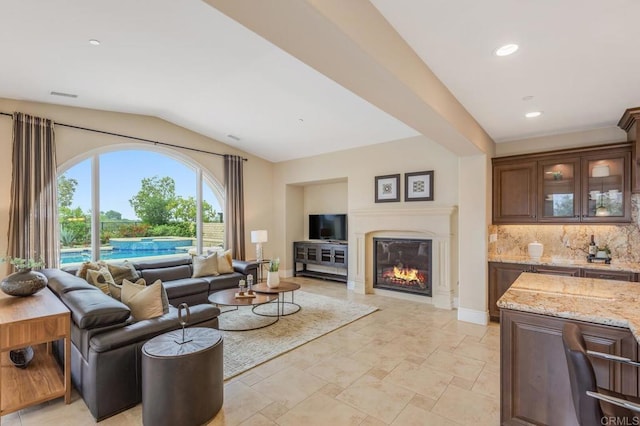 6286 Belmont Trail Ct, San Diego, CA 92130 - living room featuring lofted ceiling, baseboards, a glass covered fireplace, recessed lighting, and light stone finish floors