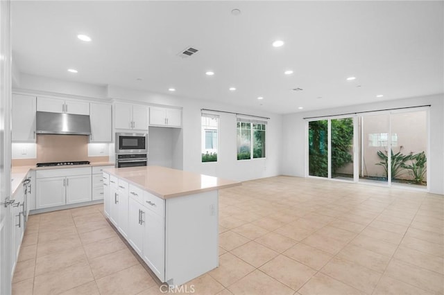 148 Stage, Irvine, CA 92618 - kitchen featuring stainless steel appliances, under cabinet range hood, recessed lighting, light countertops, and light tile patterned flooring