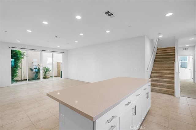 148 Stage, Irvine, CA 92618 - kitchen with a center island, light tile patterned floors, recessed lighting, light countertops, and white cabinets