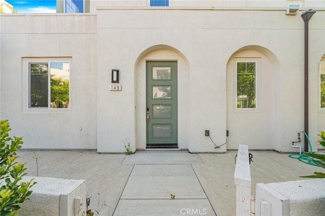 148 Stage, Irvine, CA 92618 - view of exterior entry with stucco siding and a patio area