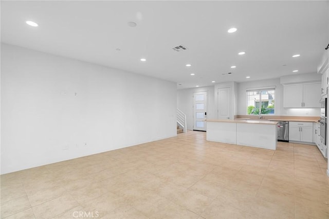 148 Stage, Irvine, CA 92618 - kitchen with stainless steel dishwasher, recessed lighting, a kitchen island, light countertops, and white cabinetry