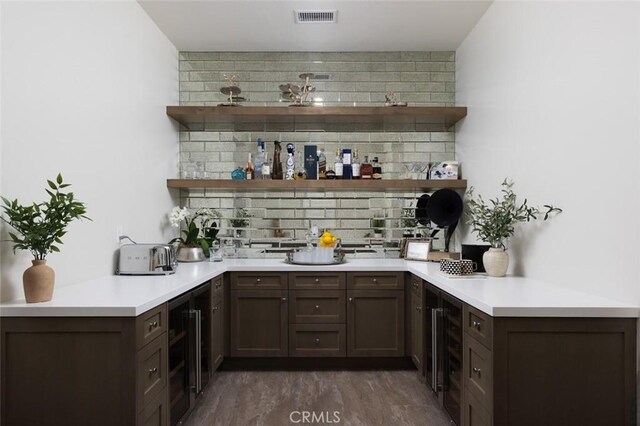 112 Mountain Sky, Irvine, CA 92602 - bar area featuring wine cooler, decorative backsplash, and dark wood-type flooring