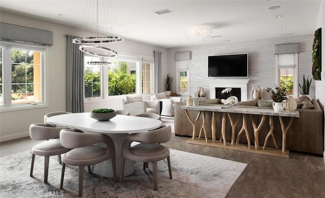 112 Mountain Sky, Irvine, CA 92602 - dining area with wood finished floors, a chandelier, and a fireplace