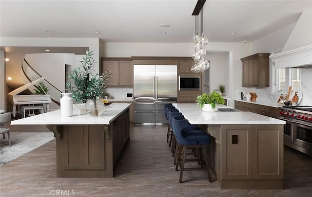 112 Mountain Sky, Irvine, CA 92602 - kitchen featuring premium range hood, a large island, built in appliances, a breakfast bar, and recessed lighting