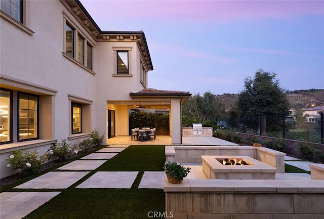 112 Mountain Sky, Irvine, CA 92602 - patio terrace at dusk featuring an outdoor fire pit, a patio, area for grilling, and a yard
