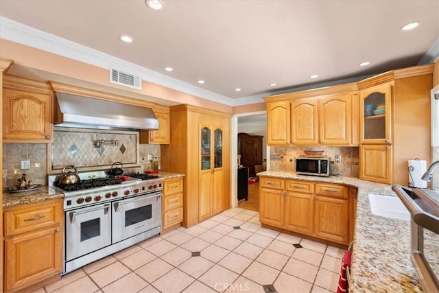 10586 Ring Ave, Rancho Cucamonga, CA 91737 - kitchen with appliances with stainless steel finishes, wall chimney exhaust hood, tasteful backsplash, glass insert cabinets, and light tile patterned flooring