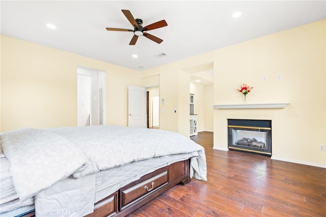 8180 E Brookdale Ln, Anaheim Hills, CA 92807 - bedroom with dark wood-type flooring, a multi sided fireplace, recessed lighting, baseboards, and ceiling fan