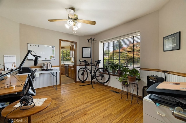 833 Saint Amant Dr, Chico, CA 95926 - home office with light wood-type flooring, ceiling fan, and wainscoting