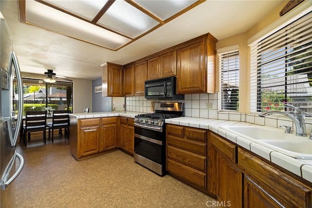 833 Saint Amant Dr, Chico, CA 95926 - kitchen featuring appliances with stainless steel finishes, brown cabinets, tasteful backsplash, and ceiling fan