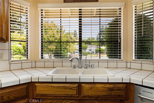 833 Saint Amant Dr, Chico, CA 95926 - kitchen featuring tile countertops, dishwashing machine, and healthy amount of natural light