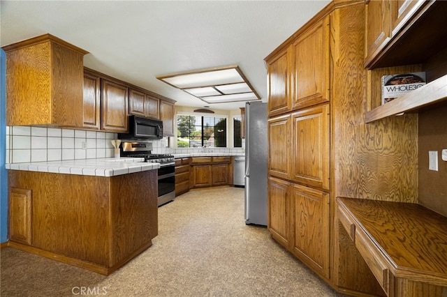 833 Saint Amant Dr, Chico, CA 95926 - kitchen featuring stainless steel appliances, brown cabinetry, tasteful backsplash, tile countertops, and open shelves