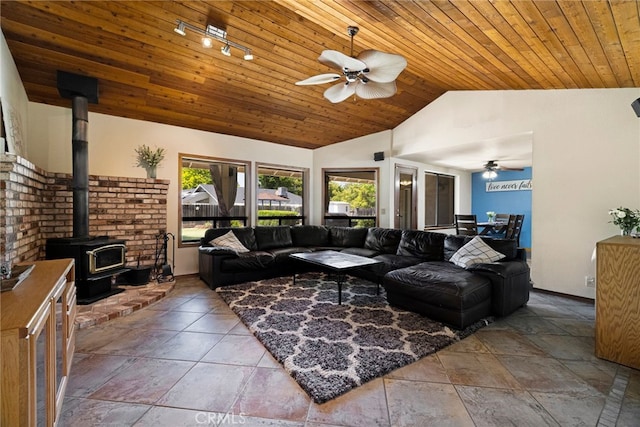 833 Saint Amant Dr, Chico, CA 95926 - living area featuring a ceiling fan, a wood stove, wooden ceiling, high vaulted ceiling, and stone tile floors