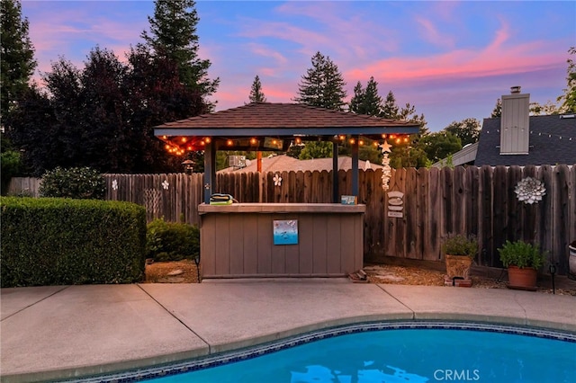 833 Saint Amant Dr, Chico, CA 95926 - pool at dusk featuring a gazebo and a patio area