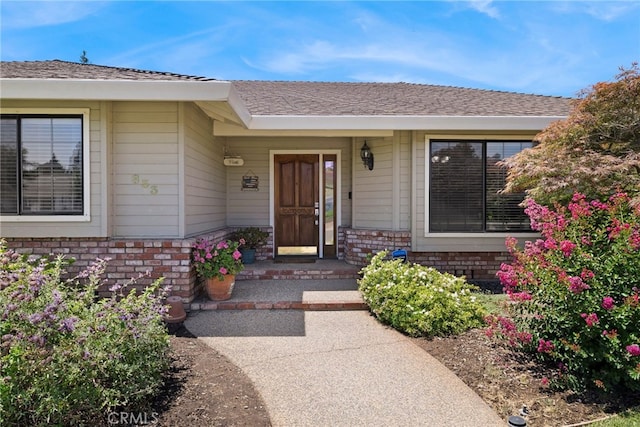 833 Saint Amant Dr, Chico, CA 95926 - doorway to property featuring brick siding and roof with shingles