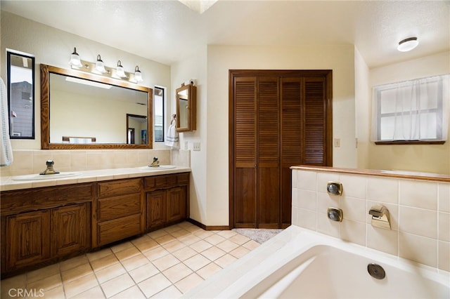 833 Saint Amant Dr, Chico, CA 95926 - bathroom with double vanity, a bath, tile patterned flooring, a closet, and decorative backsplash