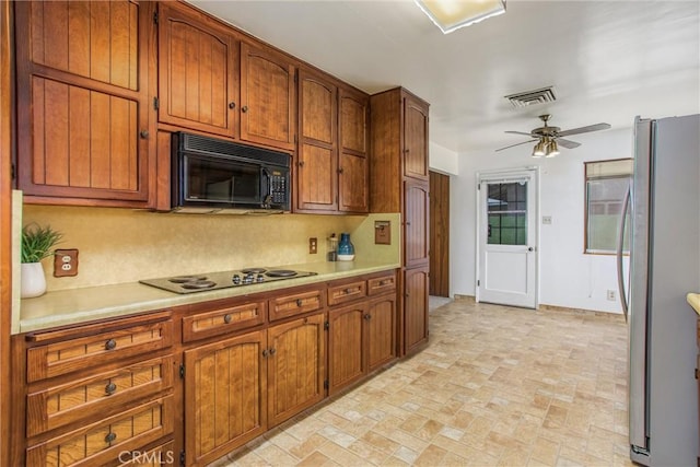 3071 Belle St, San Bernardino, CA 92404 - kitchen with black appliances, light countertops, and brown cabinets