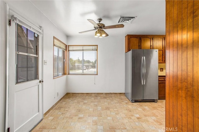 3071 Belle St, San Bernardino, CA 92404 - kitchen with freestanding refrigerator, a ceiling fan, brick patterned floors, and brown cabinets