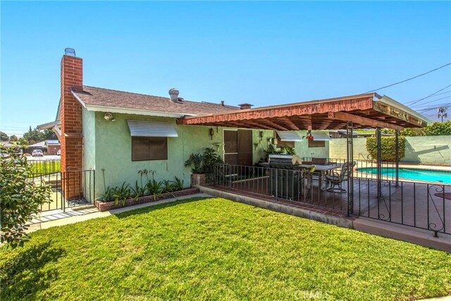 3071 Belle St, San Bernardino, CA 92404 - back of house with stucco siding, a chimney, and a patio