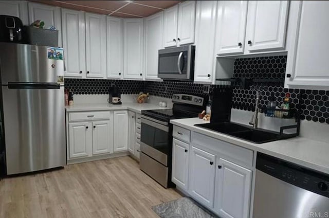 1845 Bayview Heights Dr Unit 110, San Diego, CA 92105 - kitchen with stainless steel appliances, light countertops, white cabinets, and a drop ceiling