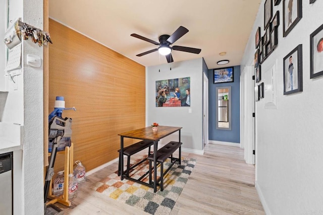 1845 Bayview Heights Dr Unit 110, San Diego, CA 92105 - dining area with a ceiling fan, light wood-style floors, an accent wall, wooden walls, and a fireplace