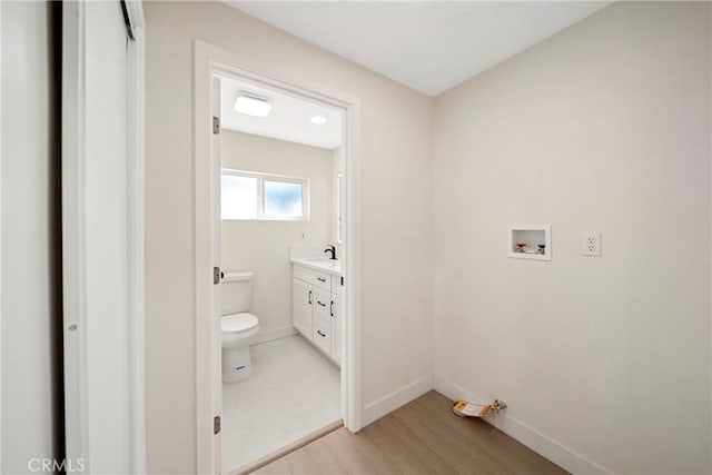 2250 Dorris Pl, Los Angeles, CA 90031 - laundry room with washer hookup, baseboards, and light wood-style floors