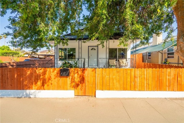 2250 Dorris Pl, Los Angeles, CA 90031 - view of front of home with a fenced front yard, covered porch, and stucco siding