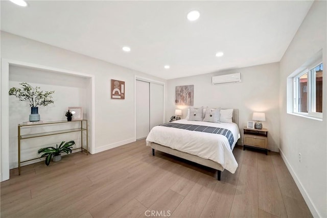 2250 Dorris Pl, Los Angeles, CA 90031 - bedroom with a wall mounted air conditioner, light wood-style flooring, baseboards, a closet, and recessed lighting