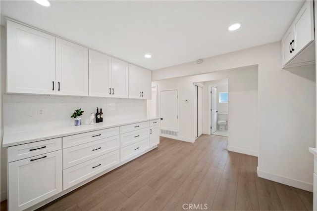 2250 Dorris Pl, Los Angeles, CA 90031 - kitchen with light countertops, baseboards, white cabinets, light wood-style floors, and recessed lighting