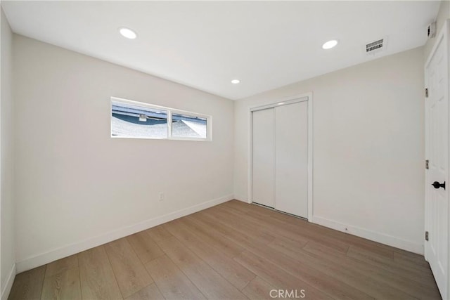 2250 Dorris Pl, Los Angeles, CA 90031 - unfurnished bedroom with wood finished floors, baseboards, a closet, and recessed lighting