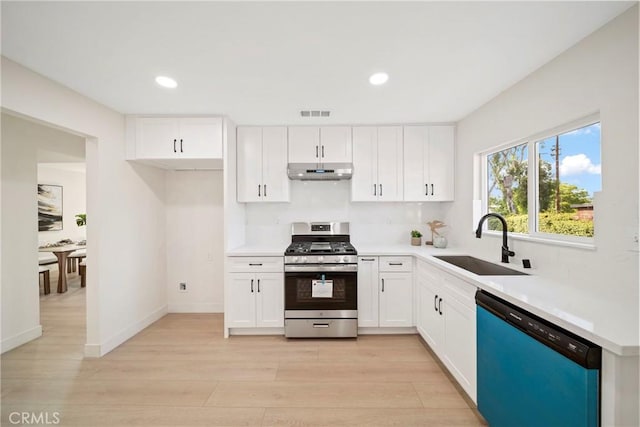 2250 Dorris Pl, Los Angeles, CA 90031 - kitchen with stainless steel range with gas stovetop, dishwasher, a sink, extractor fan, and light wood-style flooring