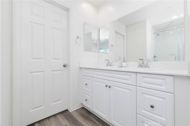 16050 Aventurine Ln, Chino, CA 91708 - bathroom featuring double vanity, an enclosed shower, and wood finished floors