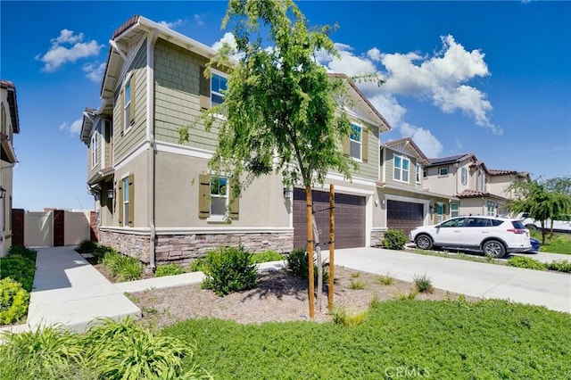 16050 Aventurine Ln, Chino, CA 91708 - view of front of house with a garage, driveway, stone siding, and stucco siding