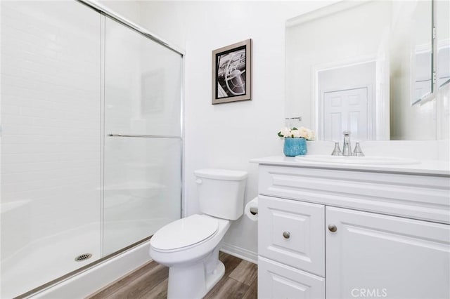 16050 Aventurine Ln, Chino, CA 91708 - bathroom featuring vanity, toilet, wood finished floors, a shower stall, and baseboards