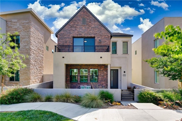484 Chorus, Irvine, CA 92618 - modern home with a balcony, a fenced front yard, brick siding, and stucco siding
