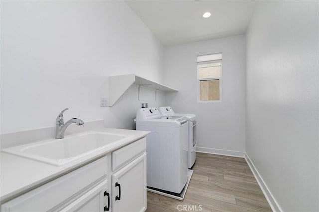 484 Chorus, Irvine, CA 92618 - washroom featuring separate washer and dryer, light wood-type flooring, baseboards, recessed lighting, and cabinet space