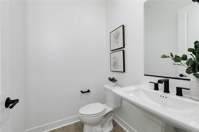 484 Chorus, Irvine, CA 92618 - bathroom with toilet, baseboards, wood finished floors, and a sink
