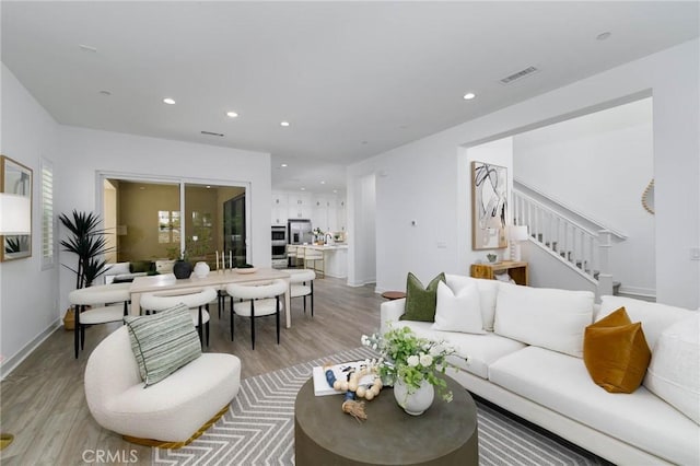 484 Chorus, Irvine, CA 92618 - living room with light wood-style flooring, recessed lighting, stairway, and baseboards