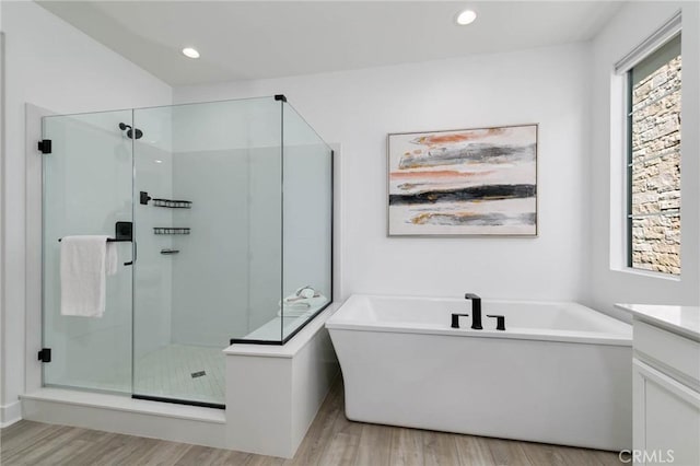 484 Chorus, Irvine, CA 92618 - bathroom with wood finished floors, a soaking tub, a shower stall, vanity, and recessed lighting
