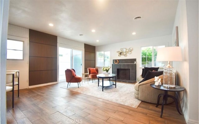8151 Orangewood Ave, Stanton, CA 90680 - living room featuring wood finished floors, healthy amount of natural light, a tile fireplace, and recessed lighting